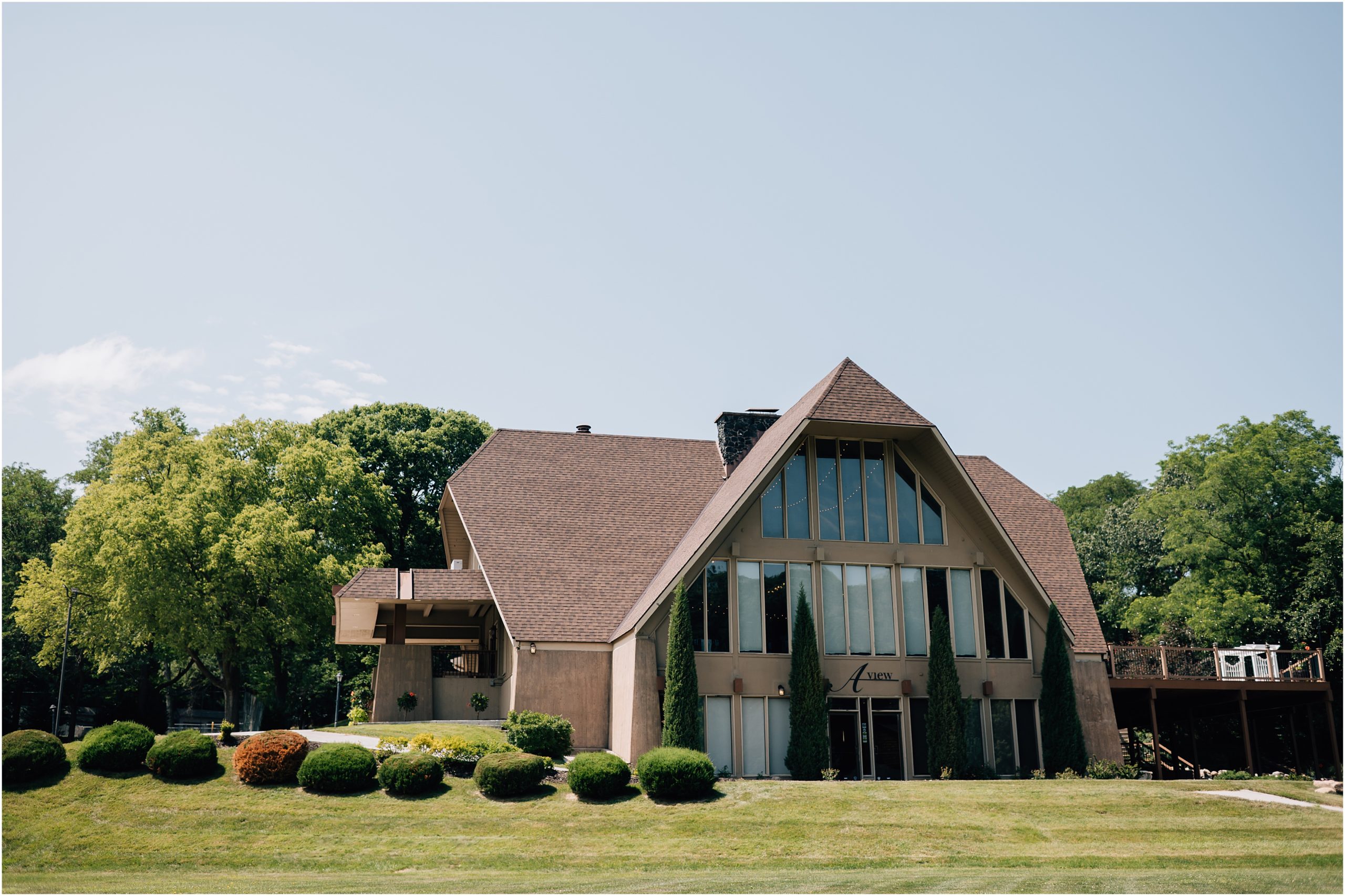 A photo of the outside of the Omaha Wedding Venue - A View in Fontenelle Hills, a wedding venue in Omaha that is in the middle of the woods. 
