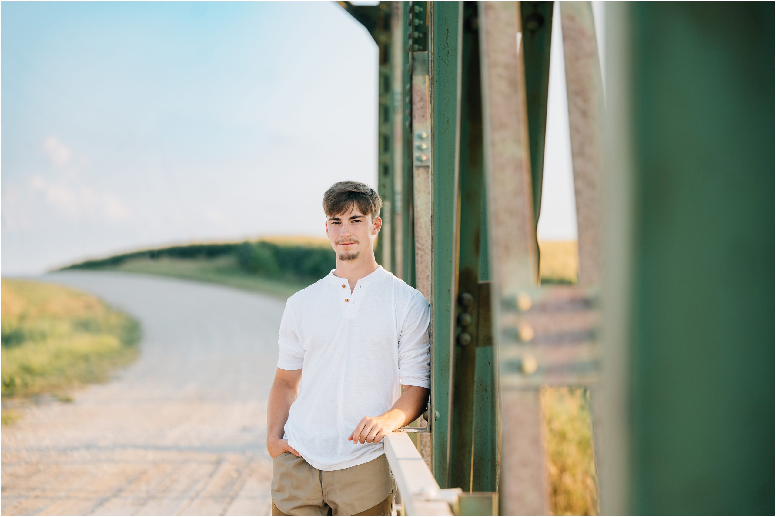 Senior Guy on bridge senior picture. Photo by Anna Brace who specializes in Harlan Iowa photography.