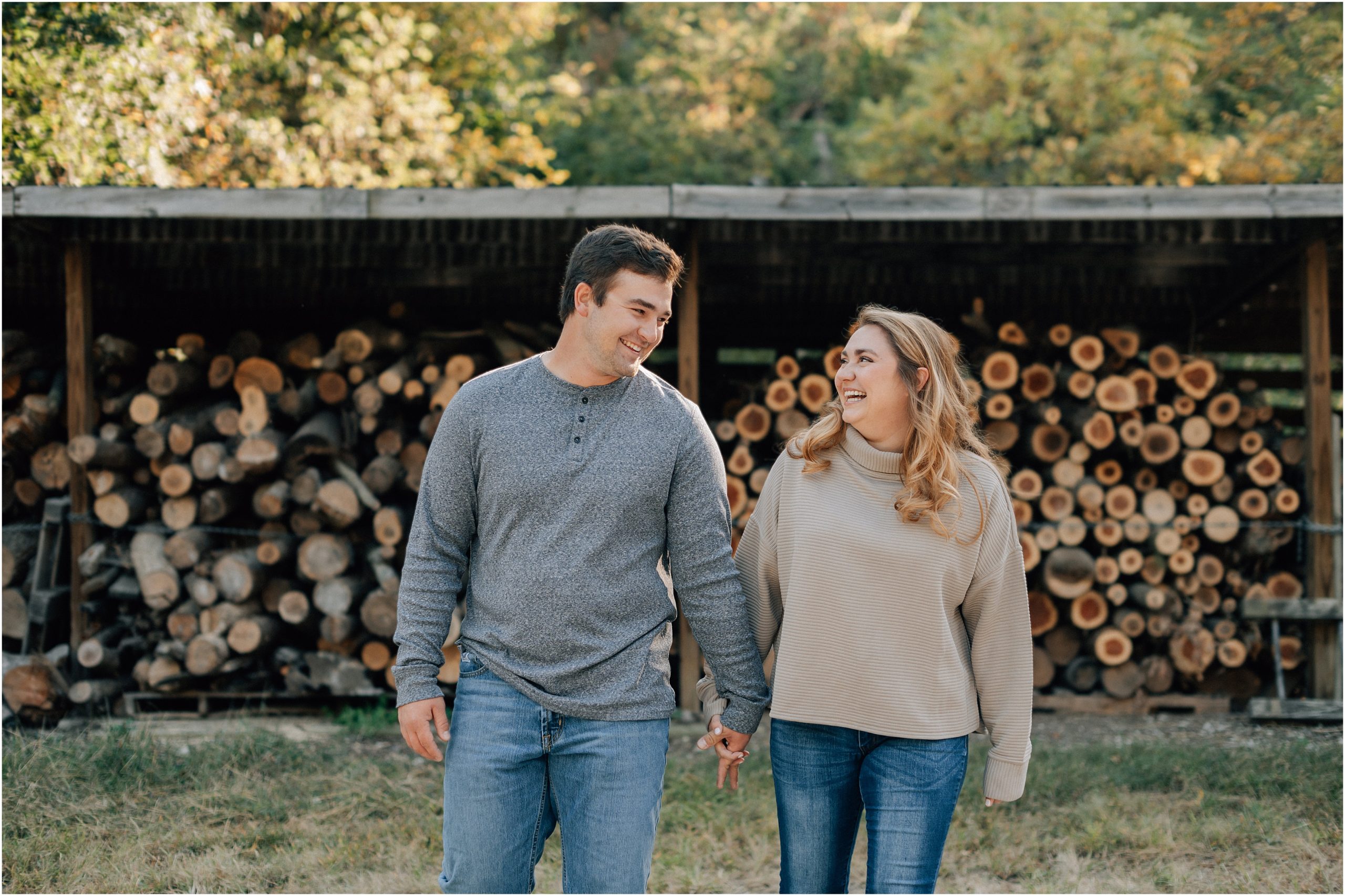 Boy and Girl walk hand in hand at their Hitchcock Nature Center Engagement photo session. Photos by Anna Brace an Omaha engagement photographer. 