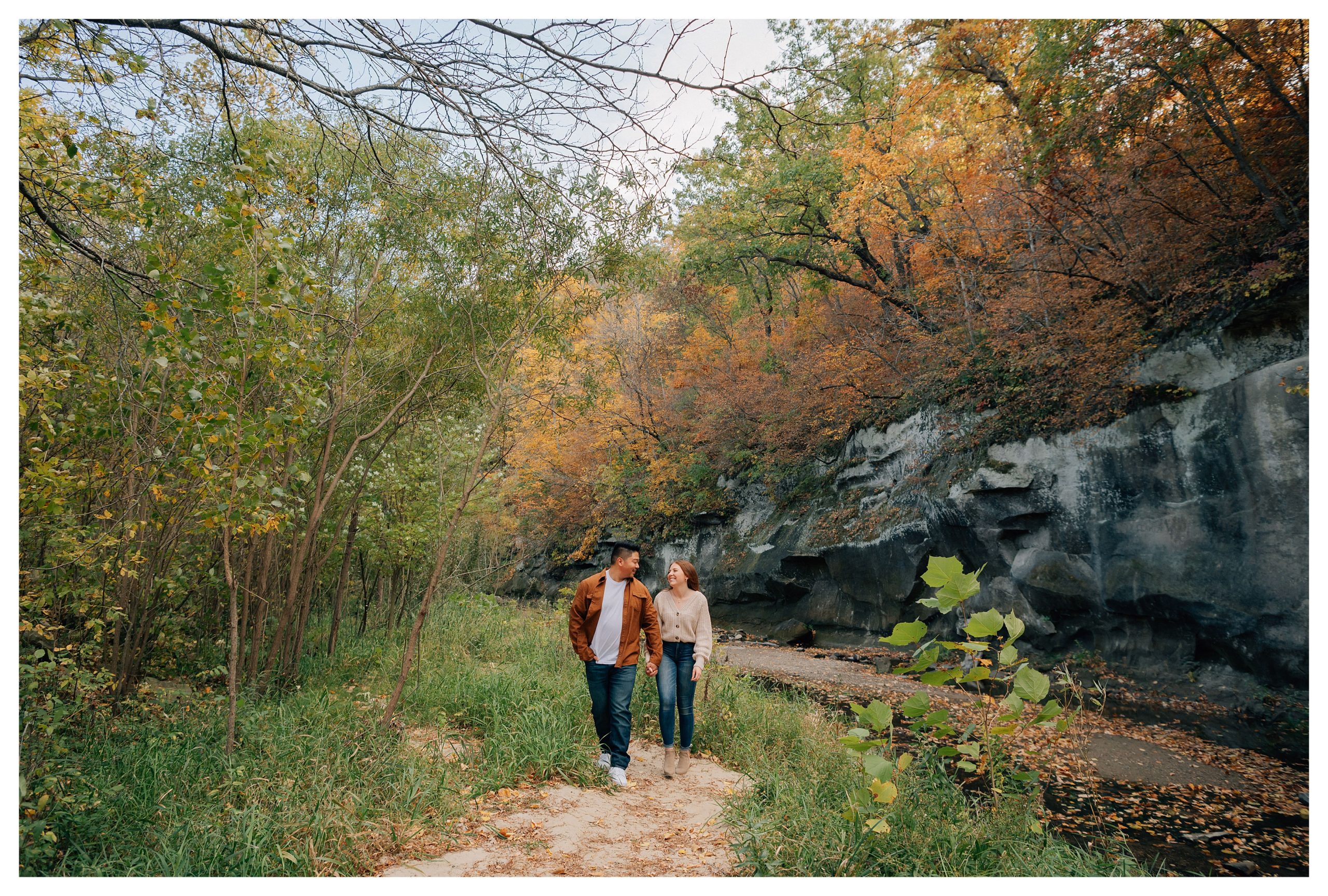 Couple walks hand in hand at their ledges state park engagement photo session. Photo by Anna Brace, who specializes in wedding photography in Des Moines. 